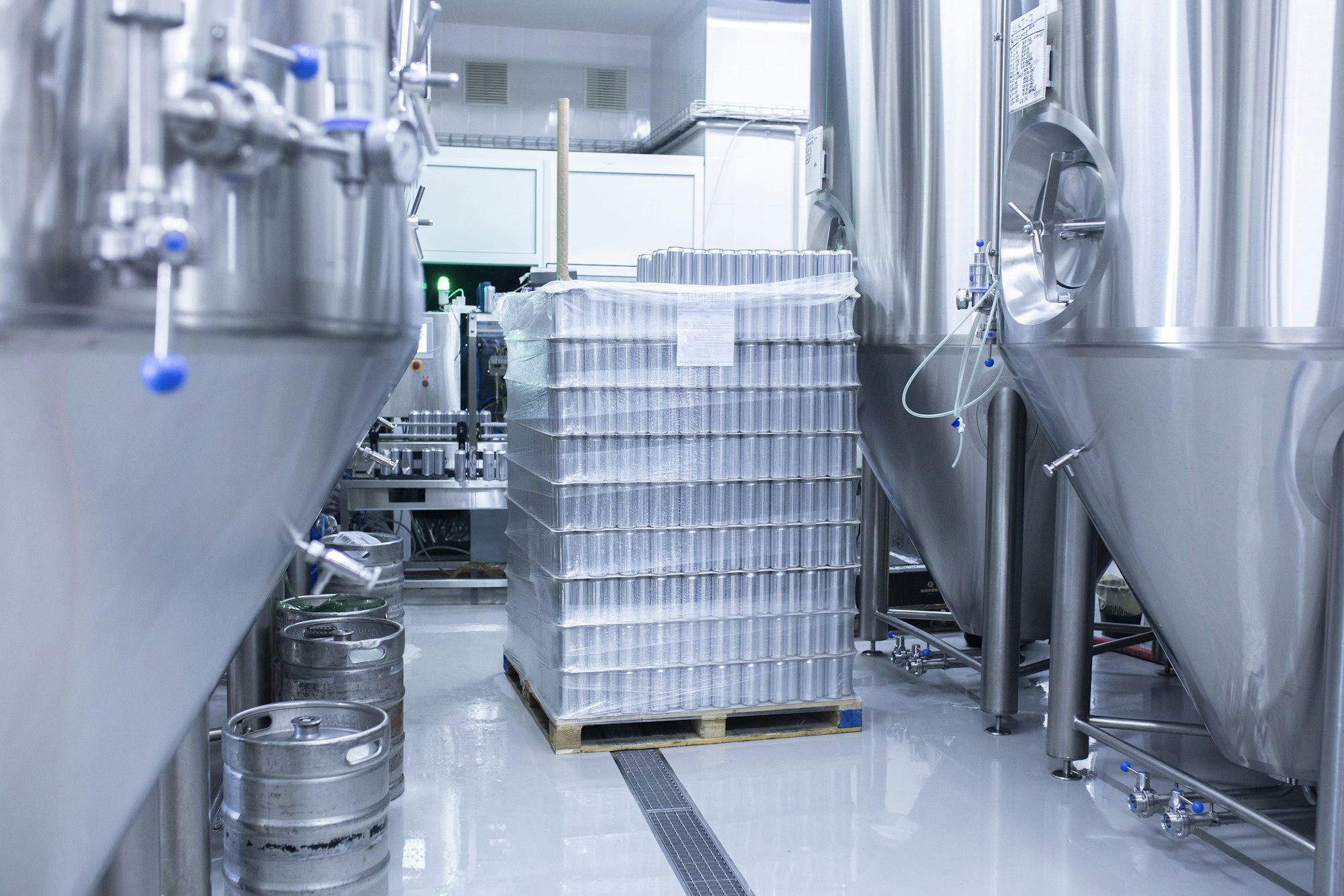 stack of new aluminium cans on manufacture, cold drink beverages production. Pallet of metal cans